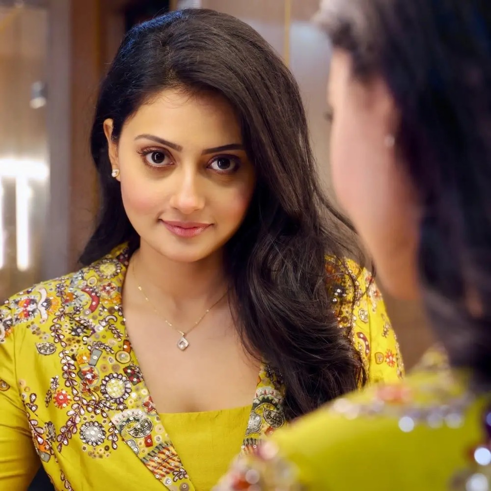 Debjani Modak in a yellow printed kurta with mirror-work embroidery, indoors