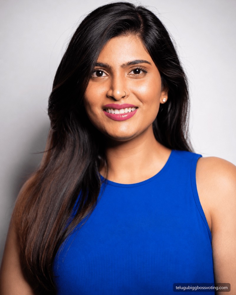 Illustrated studio portrait of Gayathri Vardhan smiling in a royal-blue sleeveless top against a plain backdrop