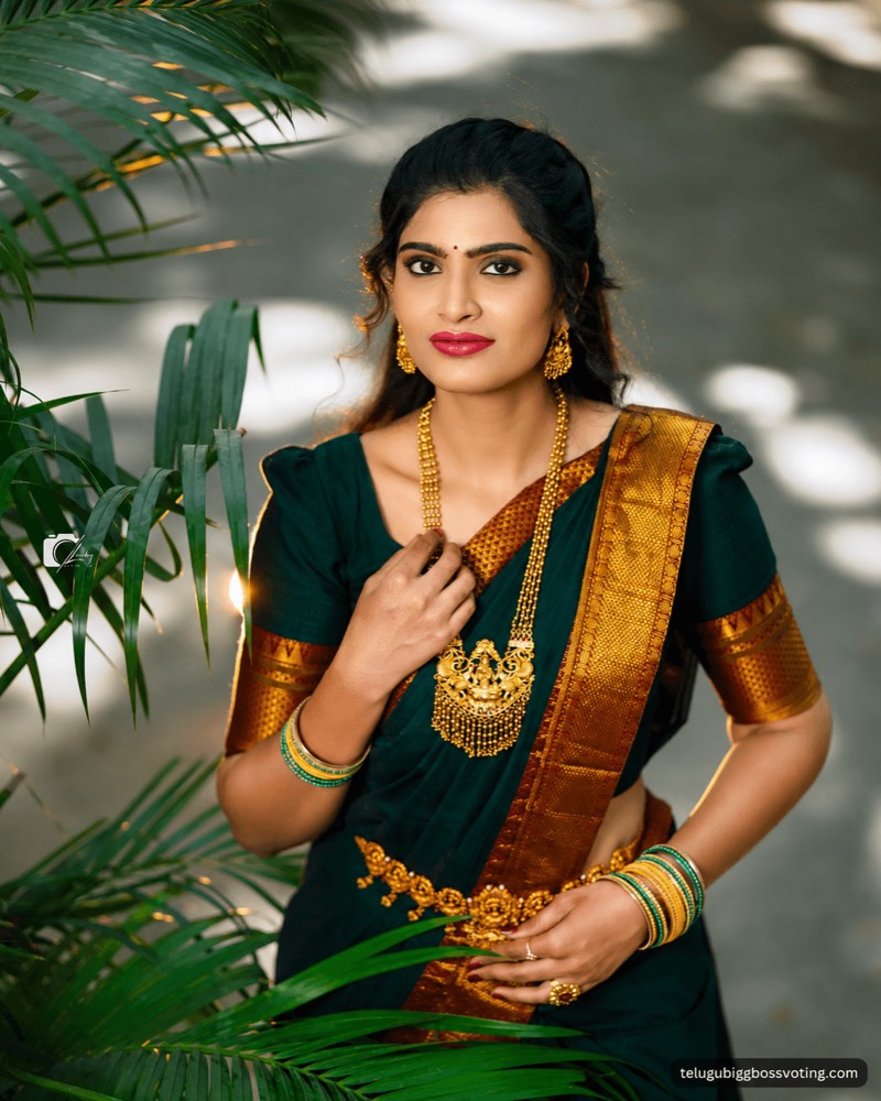 Illustrated portrait of Gayathri Vardhan in a dark green silk saree and gold temple jewellery among palm leaves