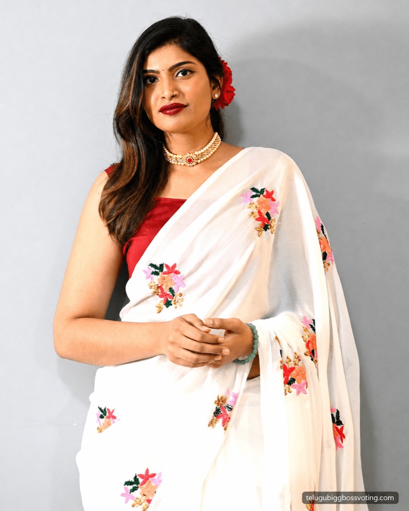 Illustrated portrait of Gayathri Vardhan in a white floral-embroidered saree with a red rose in her hair and a pearl choker