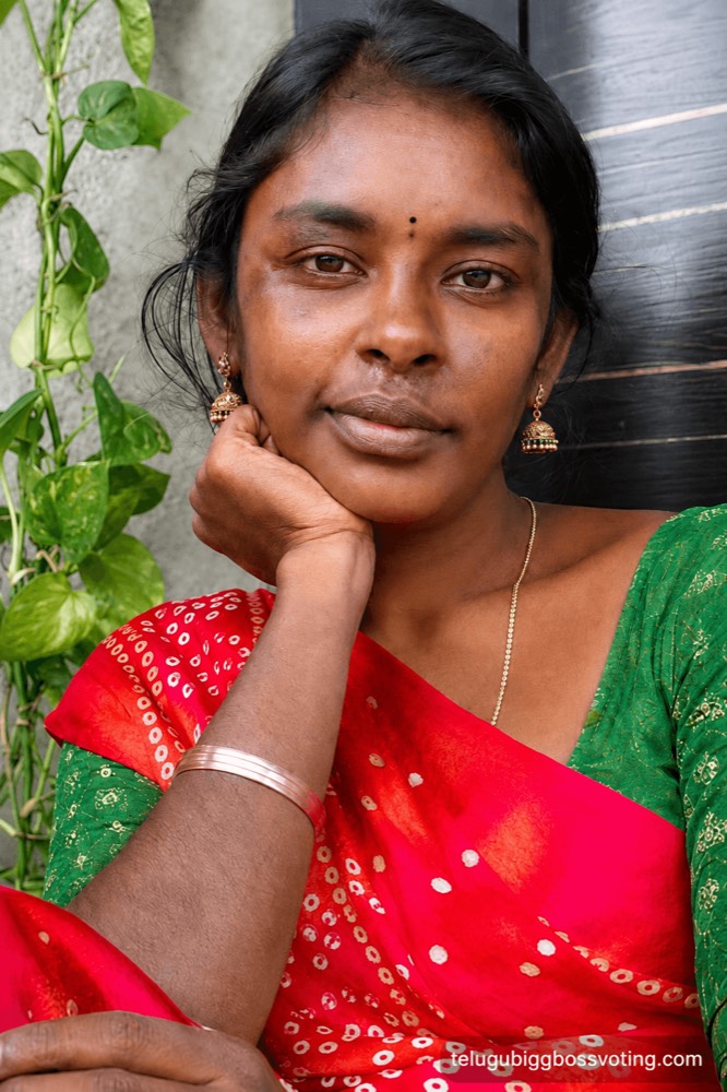 Illustrated portrait of Rajakumari Dayana in a red bandhani saree at her doorstep