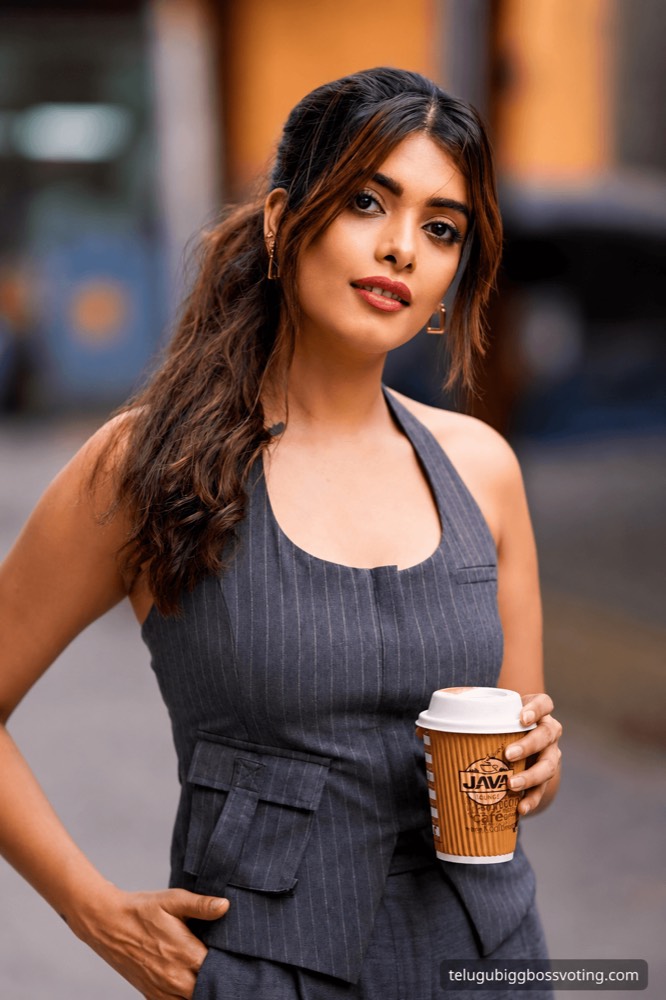 Illustrated portrait of Srishti Vyakaranam in a grey pinstripe outfit holding a coffee cup on a city street